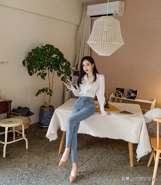 Slim fit beauty in light blue jeans, with a graceful figure showing ...