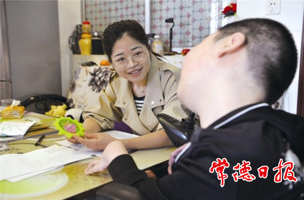 5月5日，老师为陆必文辅导功课。记者 陈欢 摄