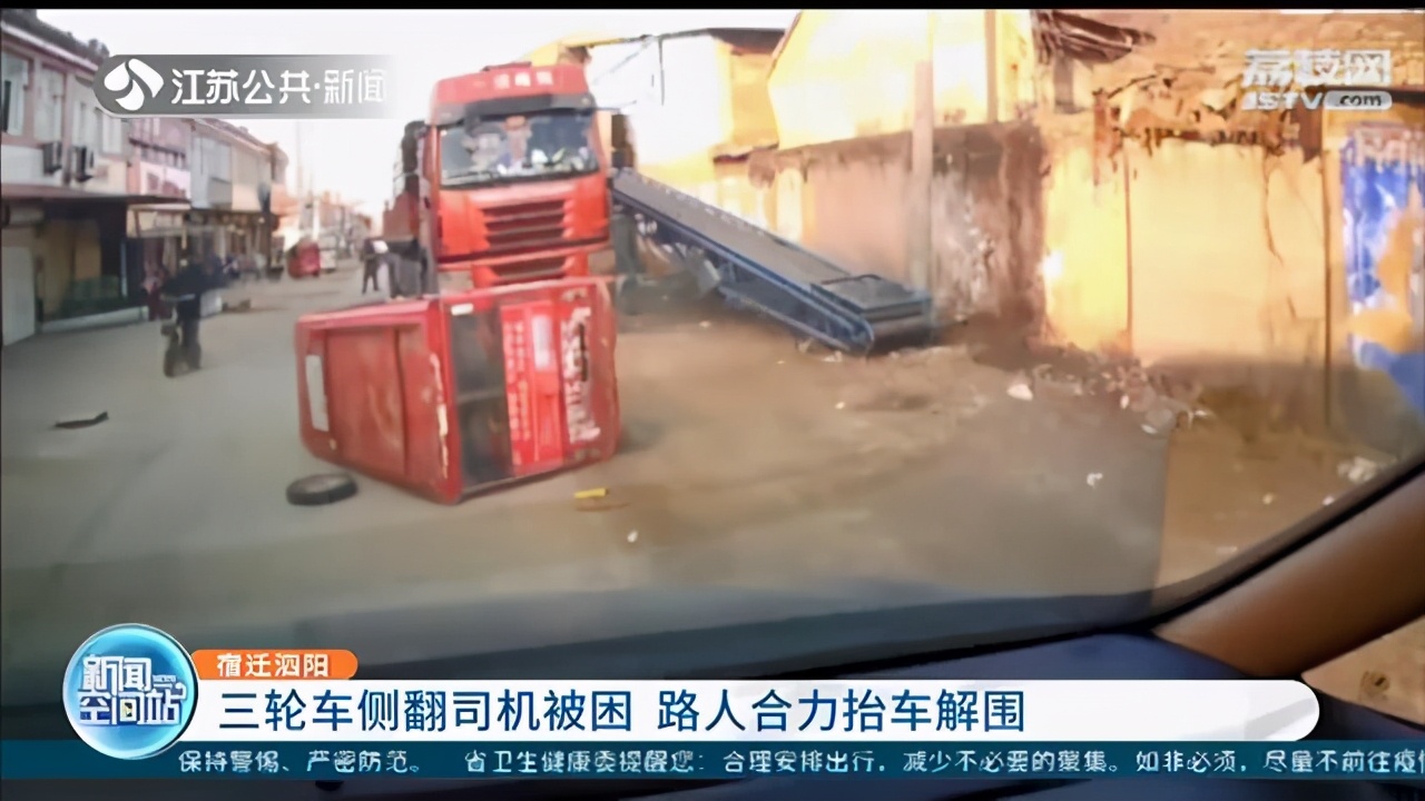点赞！三轮车侧翻司机被困 热心路人合力抬车解围